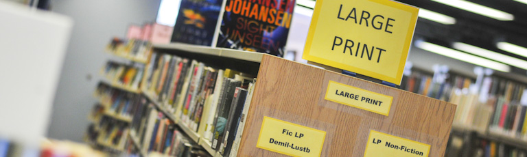 A bookshelf containing large print books